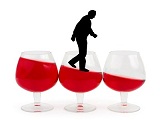 Wine glasses and alcoholic man